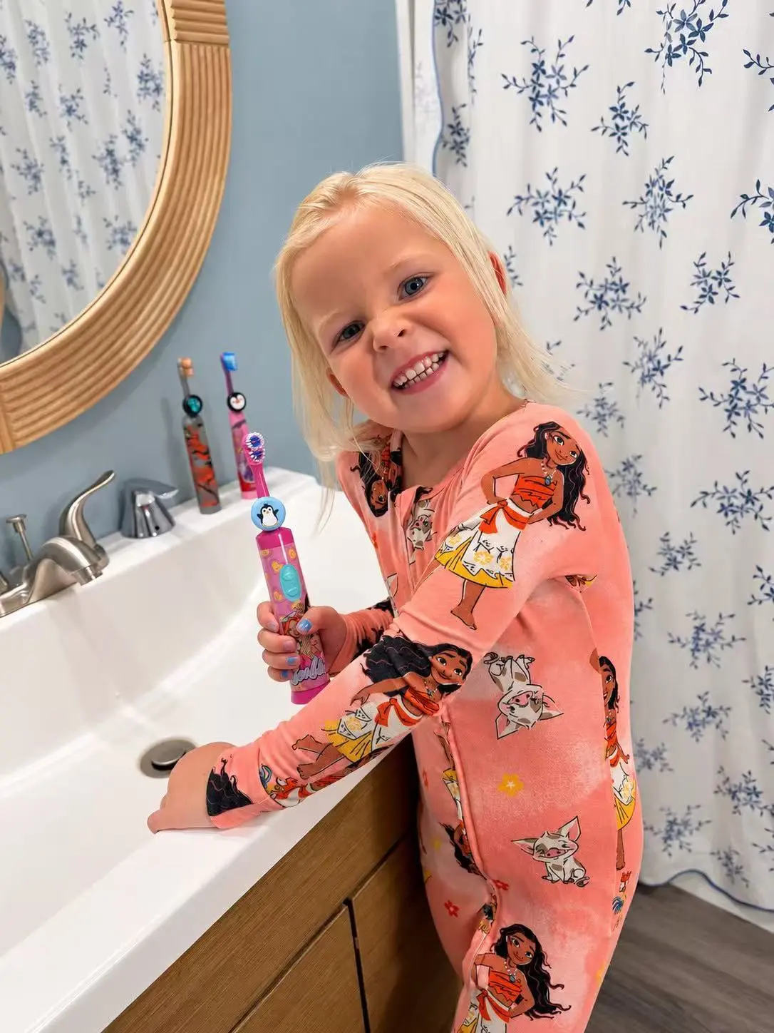 Child brushing at the sink with three Truthbrush-equipped toothbrushes