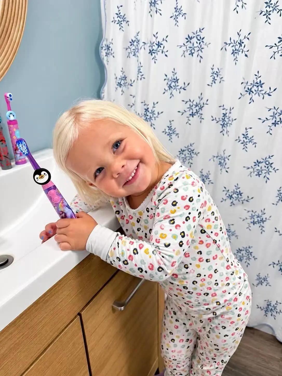 Smiling toddler next to a toothbrush with a Truthbrush Tracker