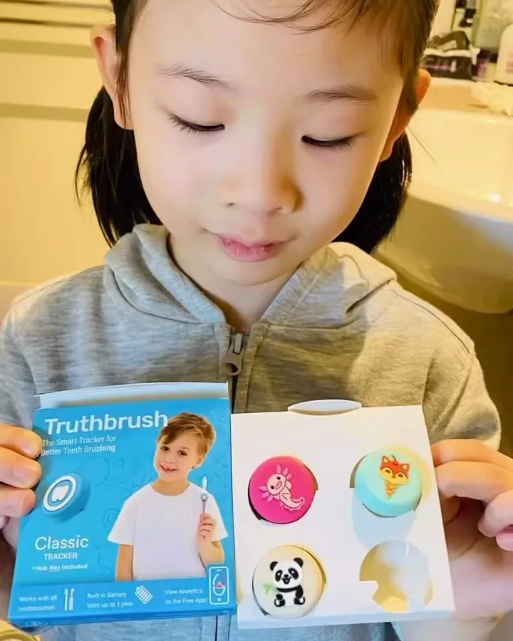 Girl unboxing a Truthbrush Classic Tracker with a tray of tracker skins